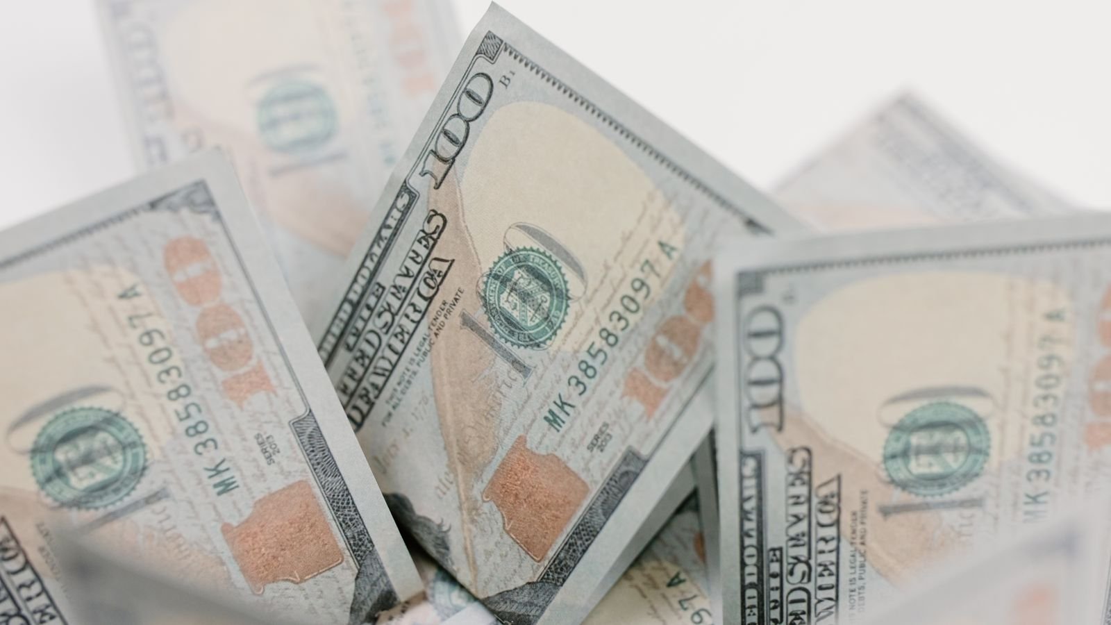 Close-up of US hundred dollar bills, representing rising mortgage borrowing costs tied to Treasury yields