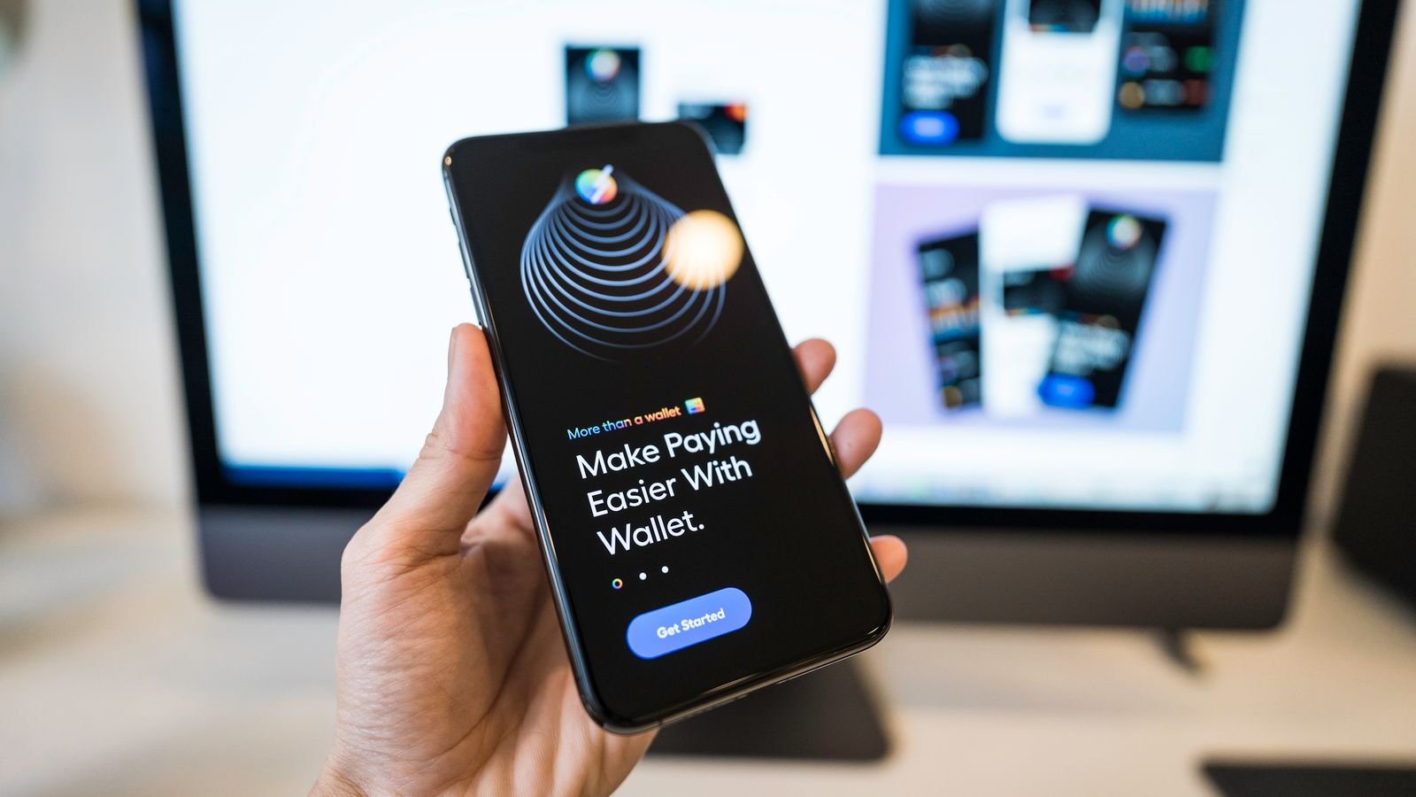Hand holding smartphone displaying a digital wallet app interface, representing tech company capital return through buybacks