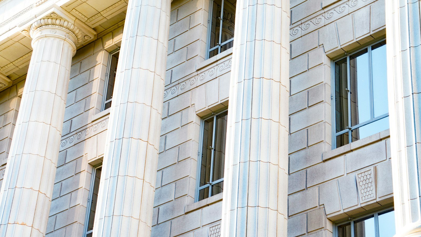 White neoclassical building with columns in daylight